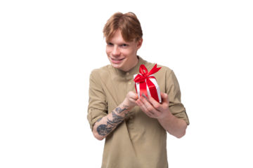 young handsome redhead man in glasses and shirt holding birthday gift box