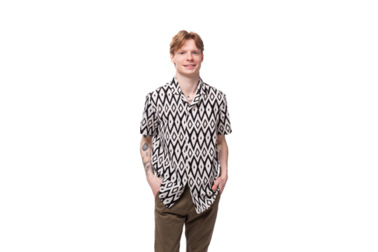 young friendly cute european man with golden hair is dressed in a stylish black and white shirt on a studio background with copy space