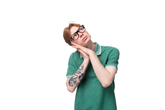portrait of a young dreaming man with red hair dressed in a green t-shirt