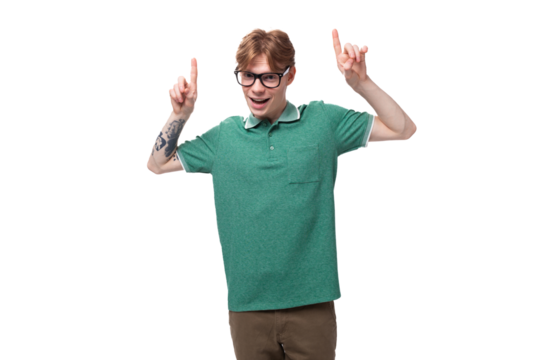 young surprised caucasian male student with red hair and tattoo reports news and points up with fingers - Powered by Adobe