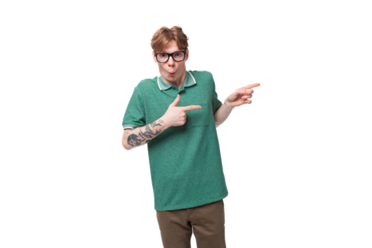young surprised red-haired man in a green t-shirt on a white background with copy space