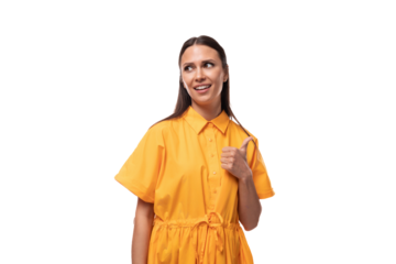 young friendly brunette woman dressed in a summer yellow dress attracts attention