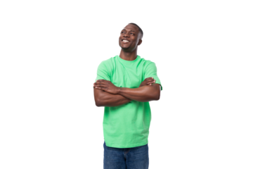 young handsome african man in light green t-shirt and jeans on white background with copy space