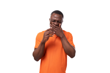 young american man dressed in orange t-shirt with print mockup laughing covering his mouth