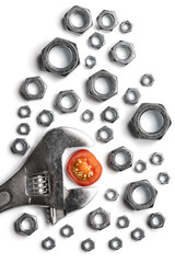 Conceptual image of a wrench, nuts and a cherry tomato slice on white background.
