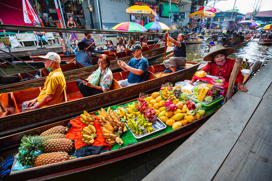 Samut Songkhram Thailand– November 05, 2023: Wooden boats ferrying people at Amphawa floating market A traditional popular method of buying and selling is still practiced in Amphawa.