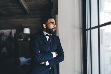 Confident ethnic businessman with arms crossed