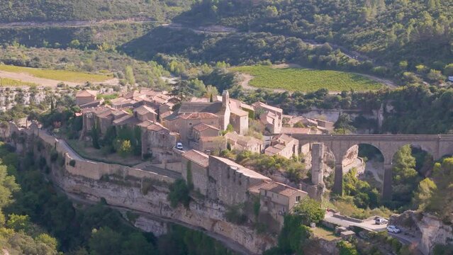 Aerial drone view of the French town Minerve which is surrounded by a canyon