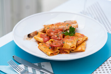 Bronze-drawn pasta from Gragnano, with Piennolo cherry tomatoes and swordfish. Traditional Italian cuisine from Naples and the Amalfi coast