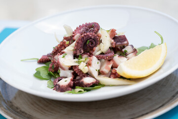Sea octopus with salad, steamed and served with Sorrento lemons