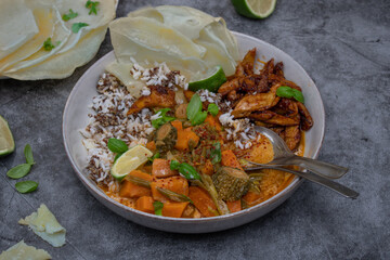 Thai vegan red curry made with seitan (plant based meat) sweet potatom rice, Along with rice and starch pancakes