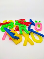 Colorful plastic letters on a white background. Education. Learning.
