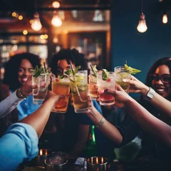 Fotobehang Close up of friends group cheering mojito drinks at bar restaurant, party time, cocktail close up © Jasmina