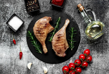 Grilled duck legs on a stone background