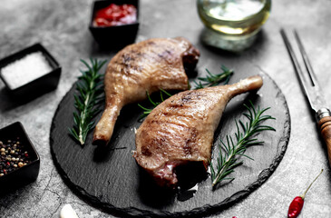 Grilled duck legs on a stone background