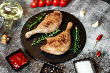Grilled duck legs on a stone background