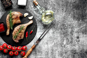 Grilled duck legs on a stone background with copy space for your text