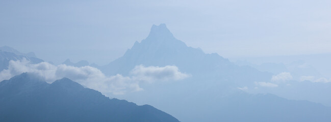 Outlines of famous fishtail mountain Machapuchare in early morning. - obrazy, fototapety, plakaty