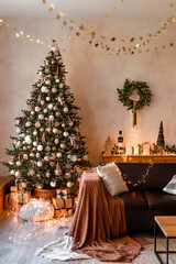 Interior of modern living room with comfortable sofa decorated with Christmas tree and gifts
