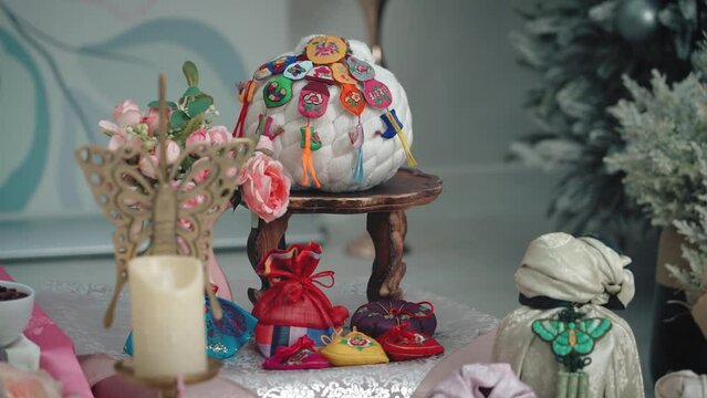 Traditional holiday of ethnic Koreans. Child's first birthday. Taking the morning table to determine fate. The video shows objects that a child should pick up. 