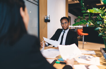 Multiethnic colleagues working on project in office