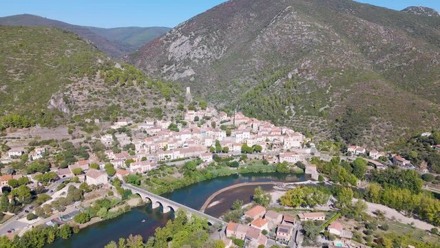 Aerial view of the typical French town named Roquebrun. A town build on a hill next to a river