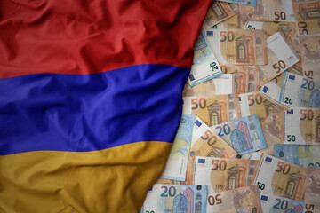 colorful waving national flag of armenia on a euro money background. finance concept