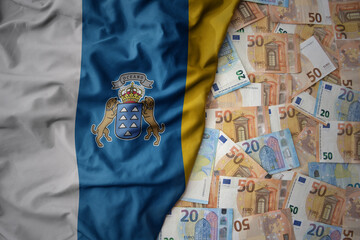 colorful waving national flag of canary islands on a euro money background. finance concept