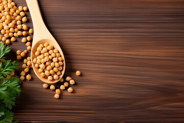 Closeup of wooden table with chickpeas and spoon Text space available