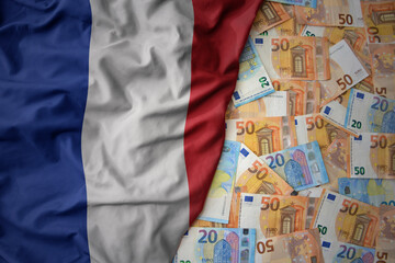 colorful waving national flag of france on a euro money background. finance concept