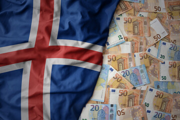 colorful waving national flag of iceland on a euro money background. finance concept