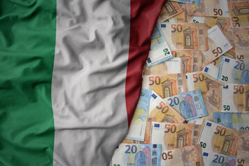 colorful waving national flag of italy on a euro money background. finance concept