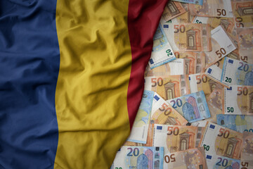 colorful waving national flag of romania on a euro money background. finance concept