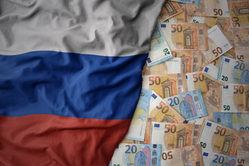 colorful waving national flag of russia on a euro money background. finance concept - obrazy, fototapety, plakaty
