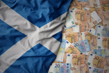 colorful waving national flag of scotland on a euro money background. finance concept