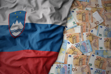 colorful waving national flag of slovenia on a euro money background. finance concept - obrazy, fototapety, plakaty