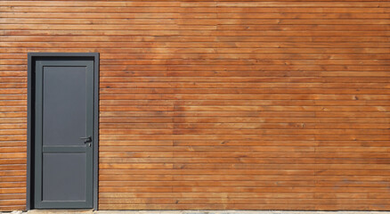 new, modern black plastic door in wooden garage , house building. Home,  exterior. front view.