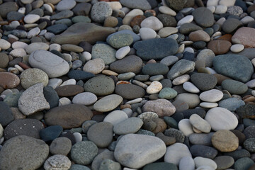 Sea of grey pebbles wallpaper. Gray beach rounded stones background. backdrop of stones on a beach...