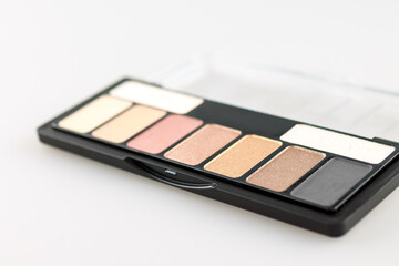 Women's palette with makeup shadows, highlighter base, selective focus
