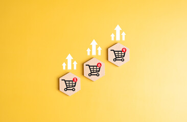 Shopping cart with arrow up icons on wooden blocks. Online shopping and delivery best service,...