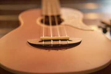 Ukulele on the table, close-up of a guitar