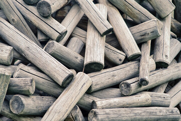 The log pile, with its rough and organic appearance, blends harmoniously with the natural surroundings.