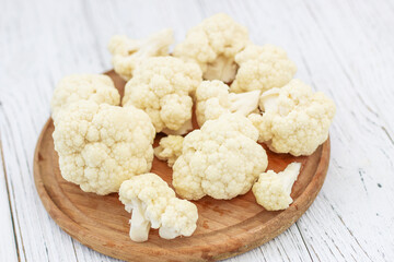 Cauliflower vegetables standing on a white wooden table