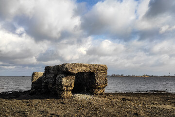 The bottom of the river after low tide, flooded remains of houses and bridges