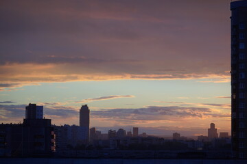 A very beautiful atmospheric sunset with a contrasting sky and dark silhouettes of high-rise buildings