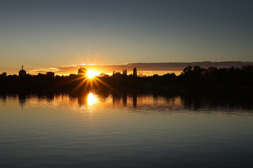 Autumn silhouette sunse in Bucharest. Beautiful sunset view with the skyscraper modern office buildings from the North of Bucharest, Baneasa and Pipera areas, during a fall sunset over Floreasca Lake.