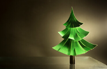 a green christmas tree made of paper