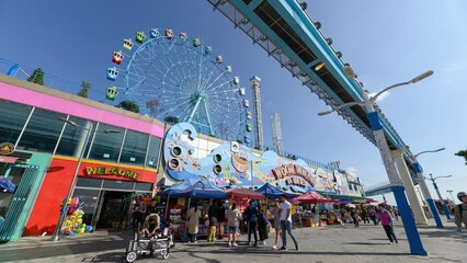 Tourists traveling in Wolmi theme park with sky train and ferris wheel on Wolmido island
