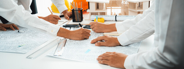 Worker, architect and engineer work on real estate construction project oratory planning with...