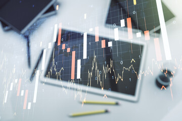 Multi exposure of abstract financial graph with world map and modern digital tablet on desktop on background, top view, financial and trading concept
